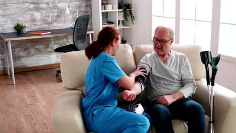 Young-female-nurse-doing-a-examination-for-blood-pressure