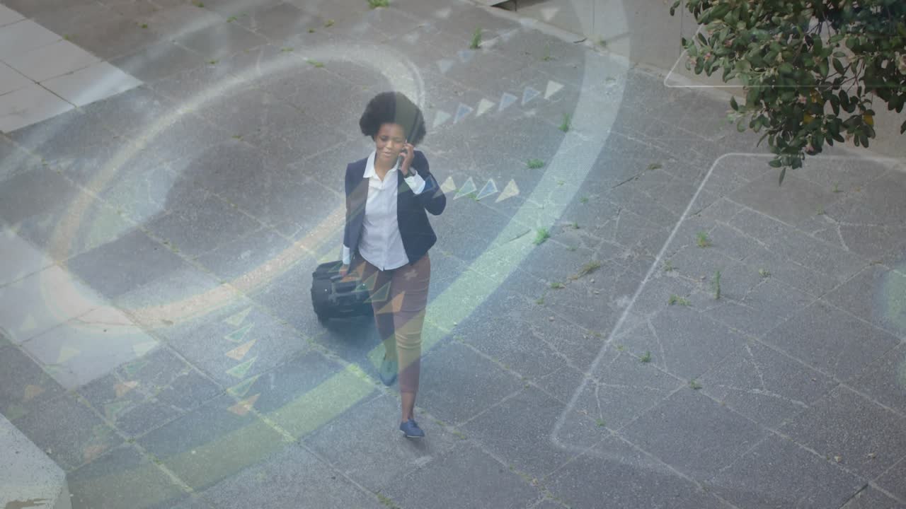Business traveler entering plaza on phone call walking pulling suitcase navigating with AR overlay