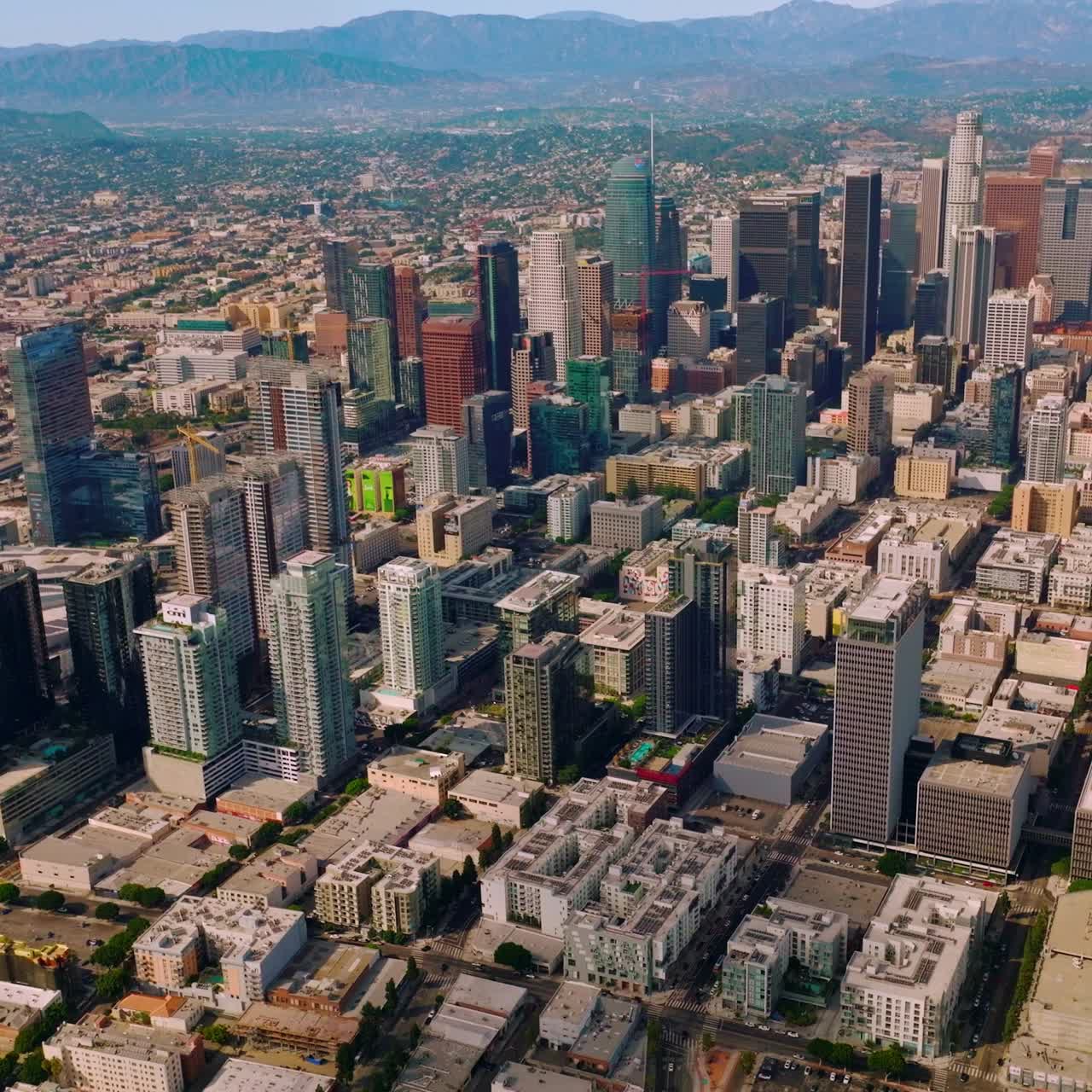 Skyscrapers and multi-storied buildings of financial Los Angeles downtown. Stunning city panorama at the backdrop of mountains