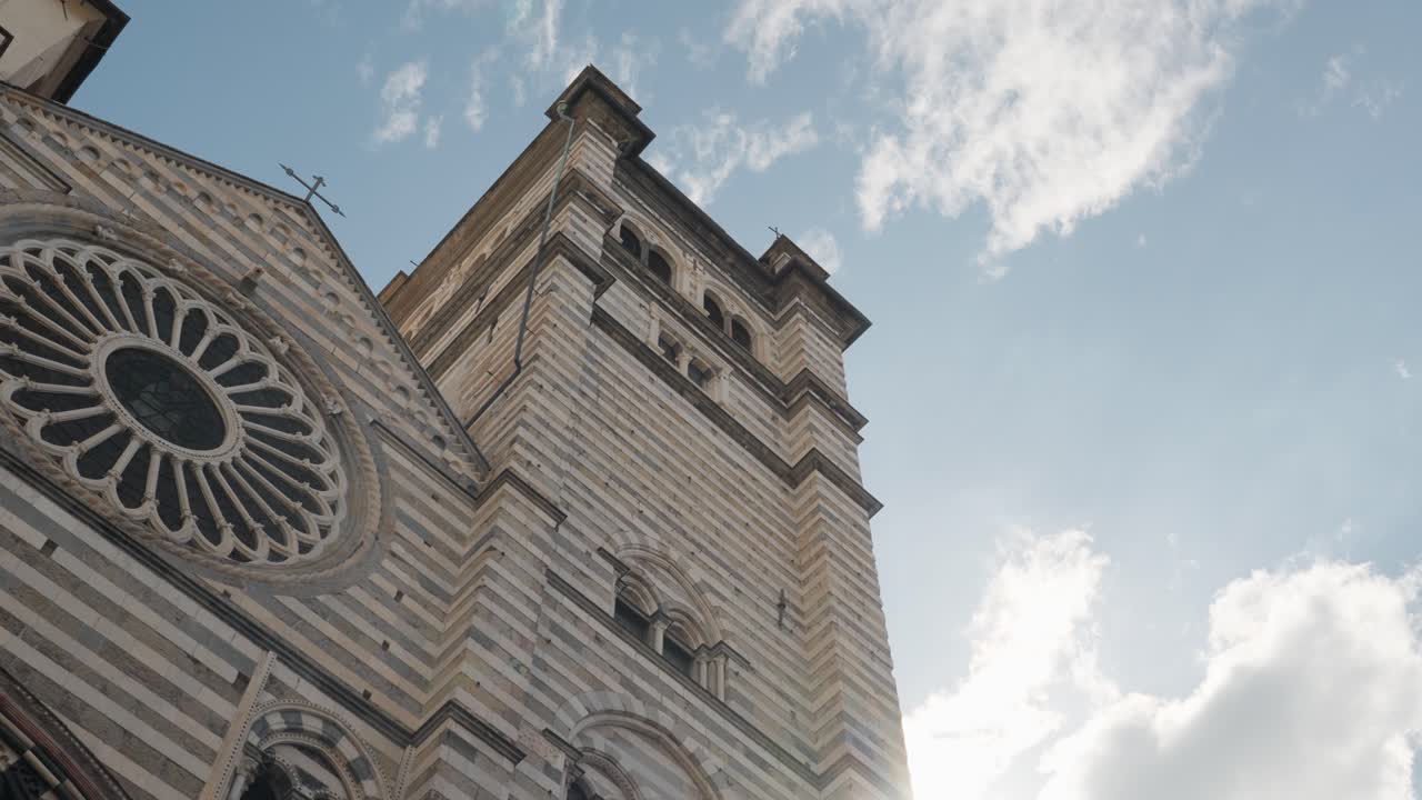 A low-angle shot of the beautiful Genoa cathedral under a clear sky, showcasing historical architecture
