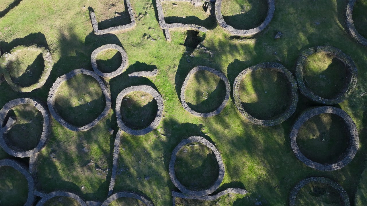 Aerial Reveal Of Stone Foundations Of Ancient Castro de Borneiro In Galicia, Spain. ascending pullback, topdown shot