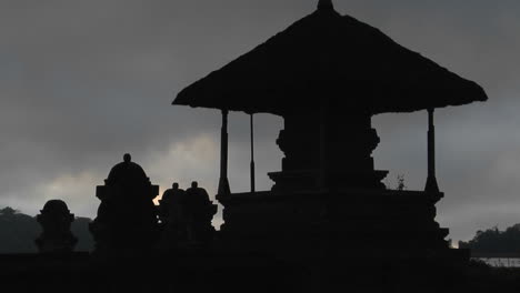 a balinese temple stands in silhouette