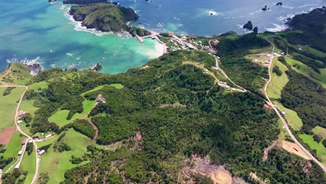 aerial view of beach coastline with tilt up view of estaquilla out to turquoise pacific ocean waters