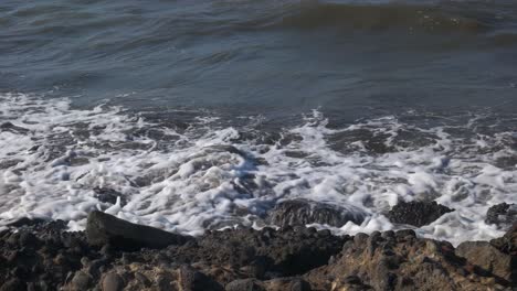 sea wave hit the rock shore sand beach