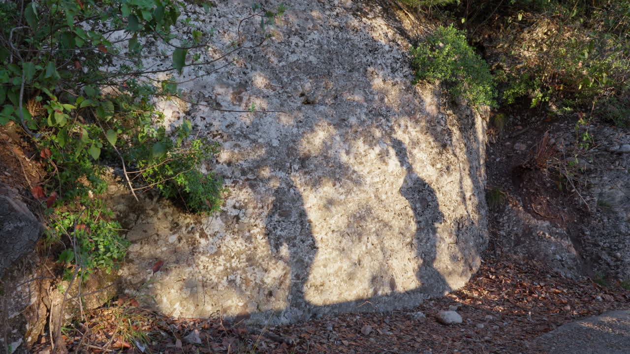 숨겨진 경로를 오르는 동안 돌 벽에 묻힌 가족의 실루 ⁇