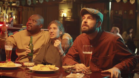 football fans watching game in pub