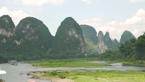 cruise ships on the li river with karst mountains guilin china