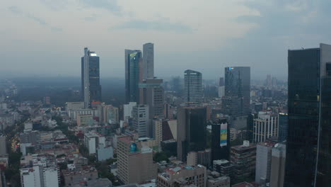 Ascending-footage-of-group-of-downtown-skyscrapers.-Aerial-view-of-tall-office-buildings-and-morning-cityscape-in-background.-Mexico-City,-Mexico.