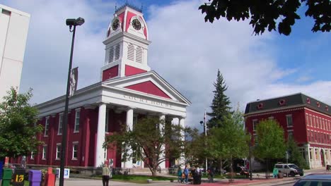 pedestrians and vehicles travel pass a historic court house in montpelier vermont