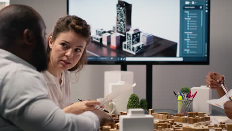 vertical video diverse engineers team go over structural real estate city planning