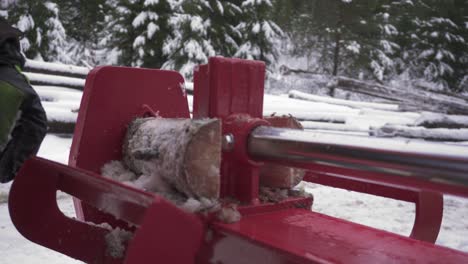 cutting woods in winter with manual log splitter