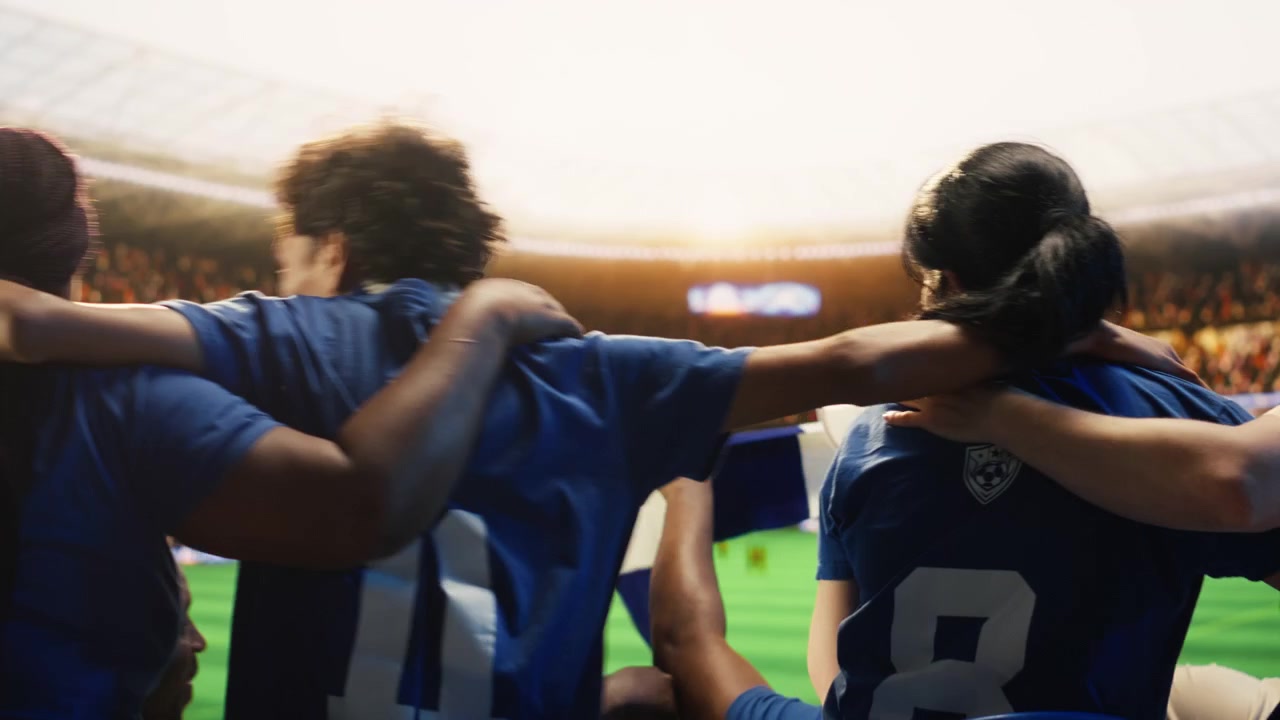 Football fans sway from side to side in stadium stands during choreography