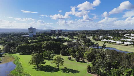 aerial view of a golf course and cityscape