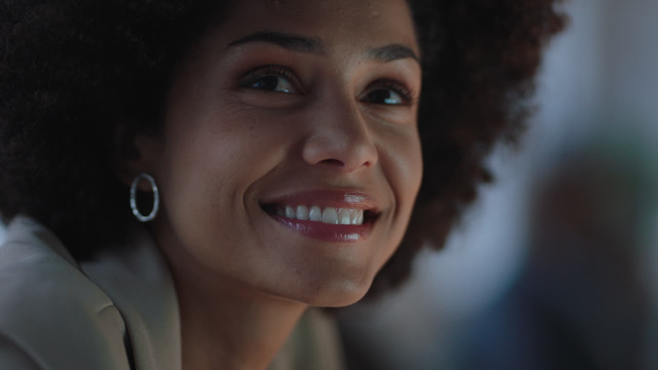 portrait beautiful mixed race woman with afro hairstyle making faces having fun gesturing peace sign in office