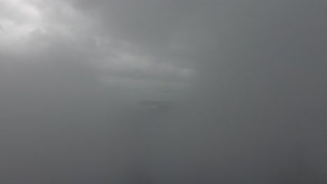 aerial drone shot in rainy clouds over a lake in mongolia