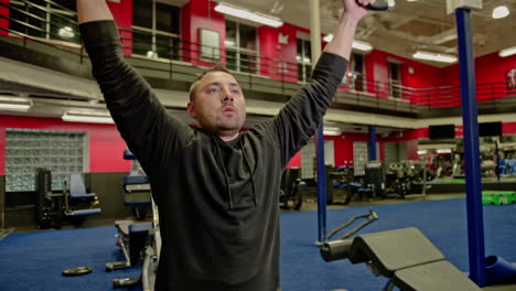 man train on sports training equipment in a fitness gym