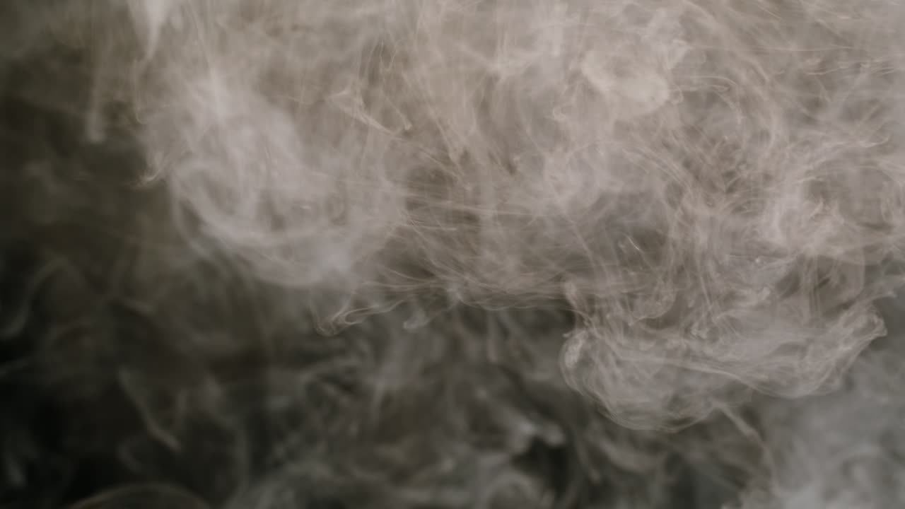 Dense White Smoke Swirling Against a Dark Background