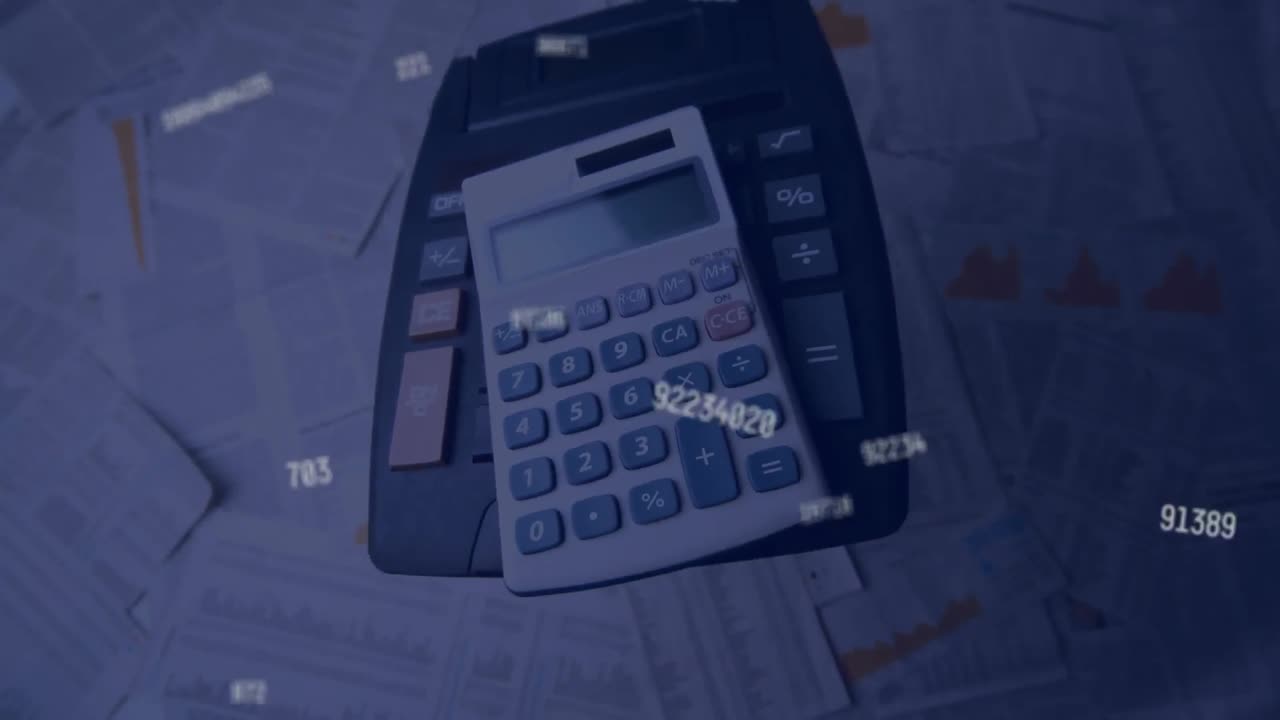 Multiple changing numbers floating against calculators falling on finance bills