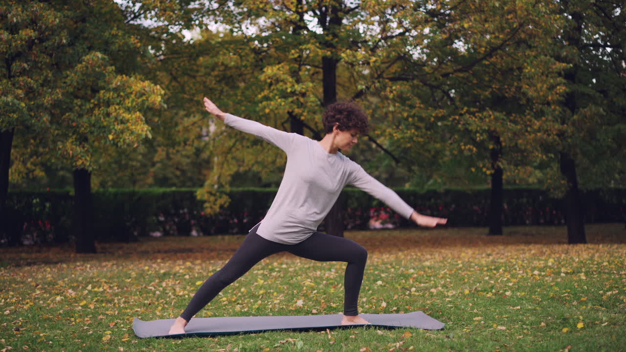 Woman Practicing Yoga in Autumn Park