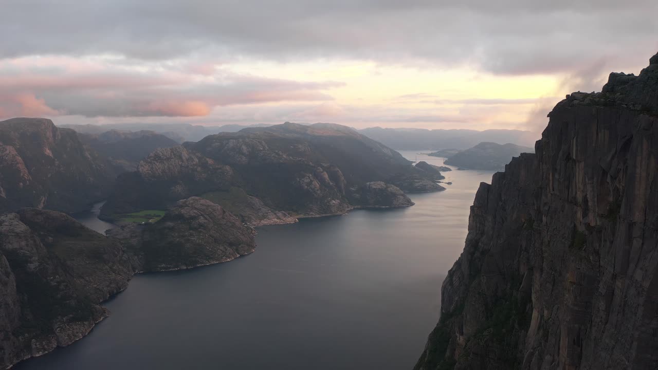 Breathtaking aerial view of rugged cliffs, fjords, and mountains in Preikestolen Norway at sunset