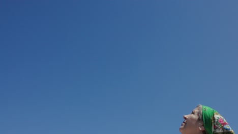 romanian woman standing under blue sky - close up