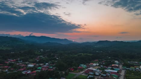 Aerial-hyperlapse-of-Quepos-city-in-Costa-Rica-with-orange-and-blue-sky,-4k