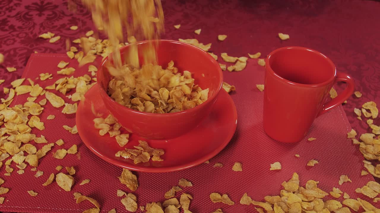 A dramatic cereal pour overflows the bowl, sending crunchy flakes everywhere