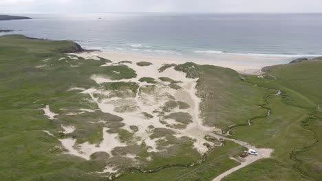 drone shot of eoropie beach in ness and the ocean beyond it on a sunny, summer's day