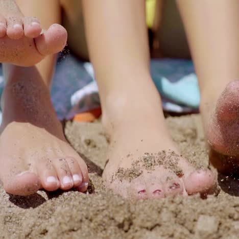 bare feet of two young women in beach sand