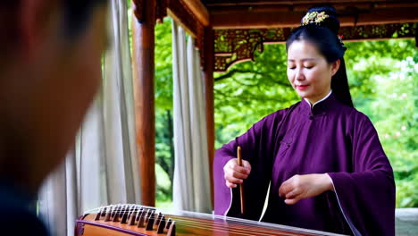 woman playing a traditional chinese zither (guzheng) in a garden pavilion