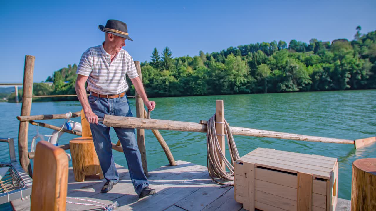 caucasian raftman push oar. Timber log raft experience Drava river. Slow motion