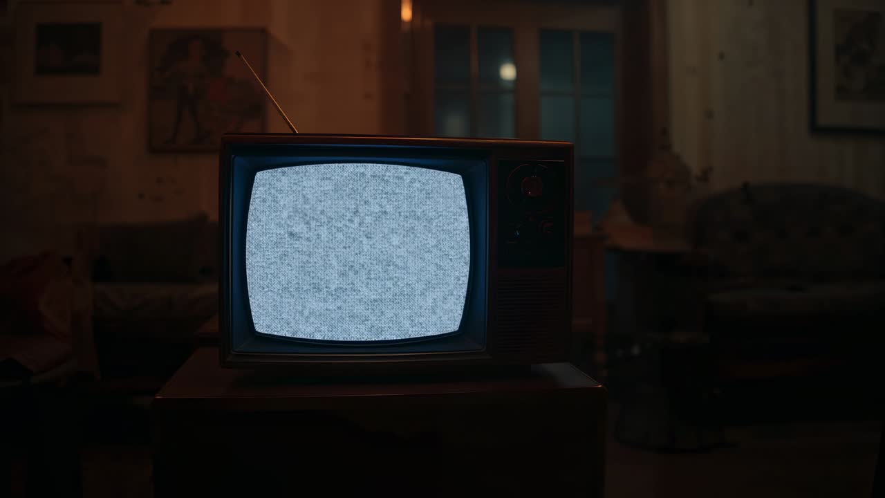 Powering on TV with antenna glowing orange, fading to white, shifting into static in paneled room