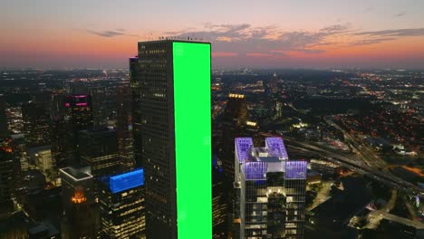 green screen banner tracked on a skyscraper wall, dusk city background - vfx visuals