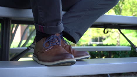 close-up-of-brown-leather-shoes-on-bleachers