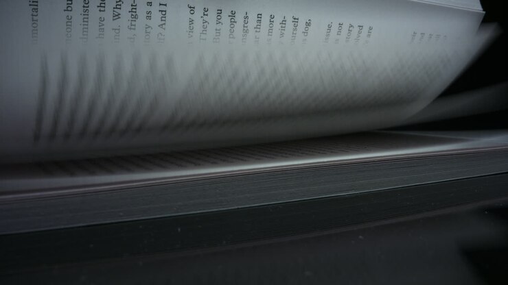 Closeup turning pages of book. Detailed view leafing book sheets