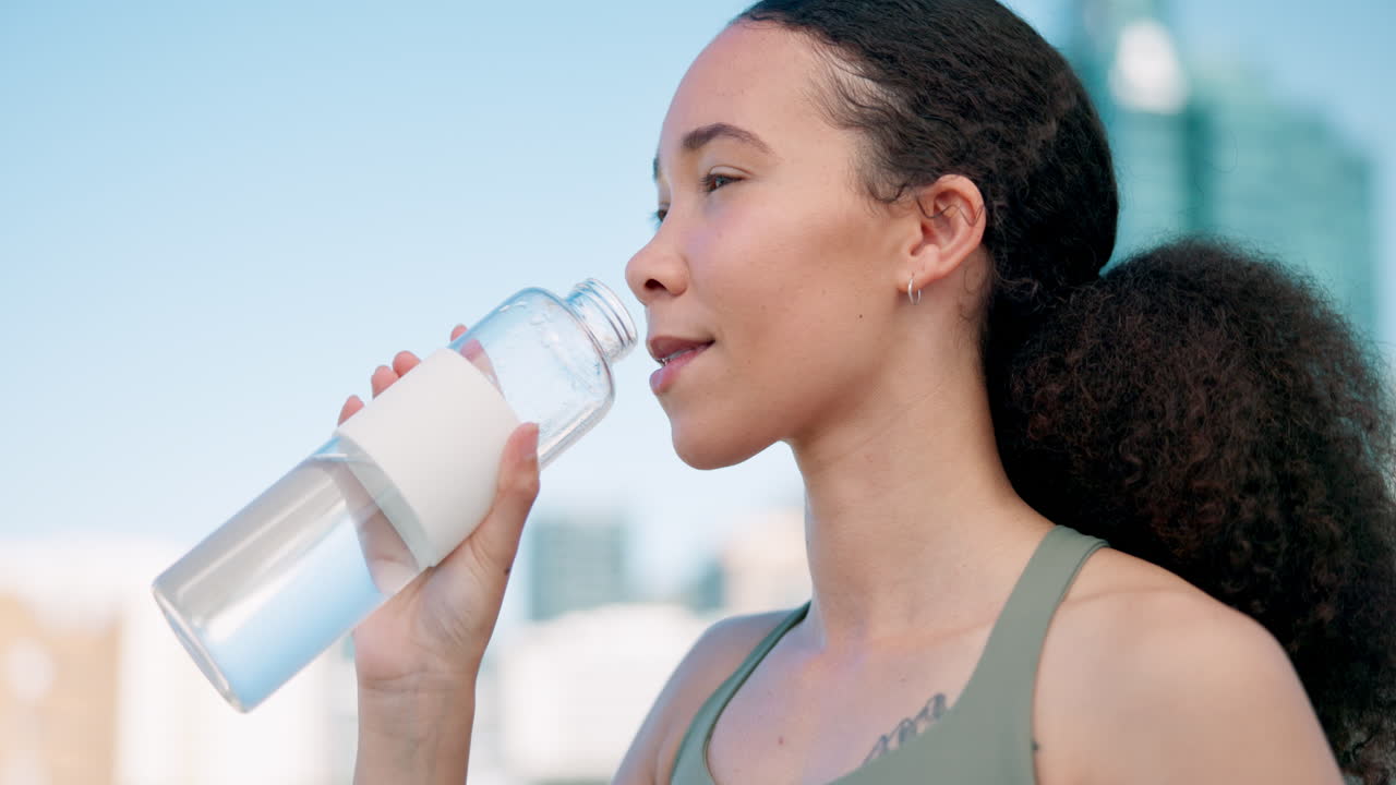 City, wellness and woman drinking water