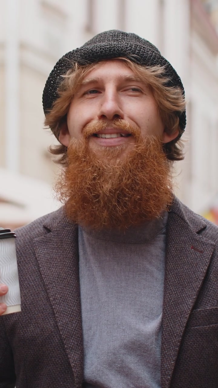 Young man enjoying drinking morning coffee hot drink relaxing taking a break in city street