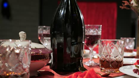 close-up female hand picking up a wine glass from the table at a formal dinner party