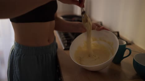 woman mixing cake batter in kitchen