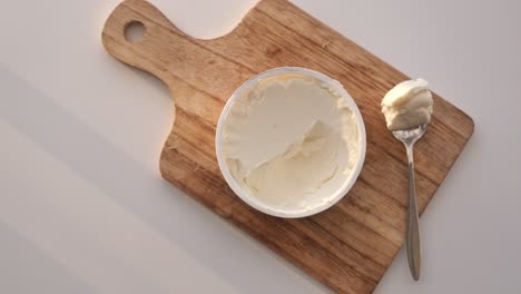 cream cheese on a wooden cutting board