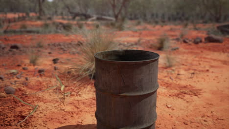 old empty rusted barrel on sand