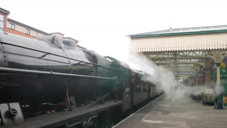 A-vintage-steam-engine-train-at-an-old-railway-station-on-platform-two