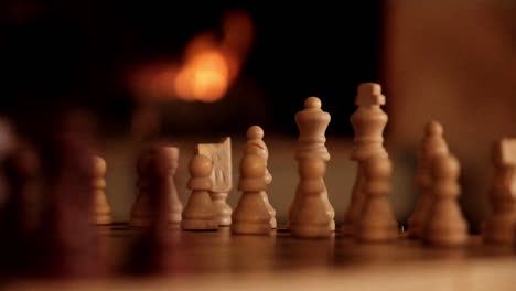 Chess-pieces-set-up-for-a-match-in-front-of-a-fire