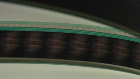 a film strip spool through a projector in this abstract shot