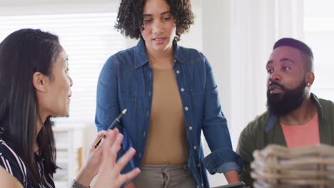 diverse male and female friends smiling and talking, working at home in slow motion