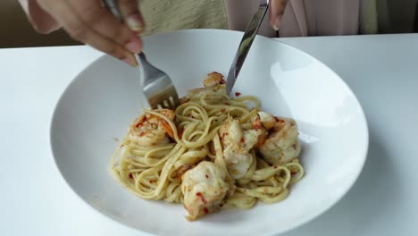 woman eating shrimp pasta