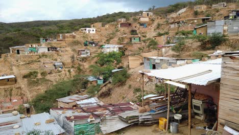 typical south american slum with simple huts on hill in poor district