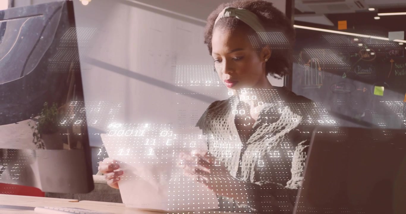 Data analyst pulling report pages, inspecting charts and typing notes with digital graphs animating