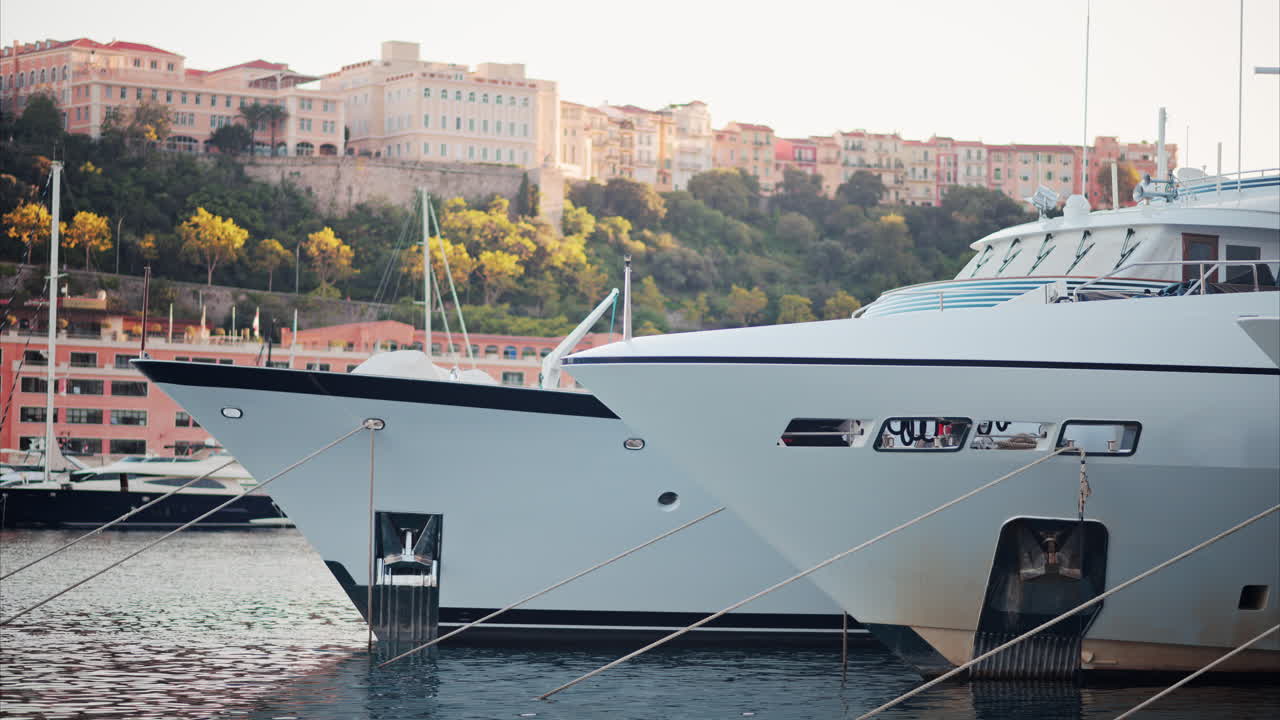 View of boats docked in the Monaco Marina with the skyline of the city on the background