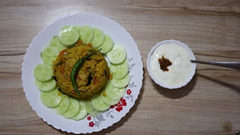 delicious vegetable biryani with yogurt and cucumber